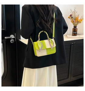 Detailed back view of a mint green patchwork crossbody bag with decorative silk scarf