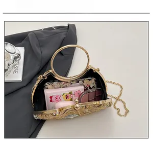 Capacity display of sequined evening clutch showing phone, wallet, and cosmetics