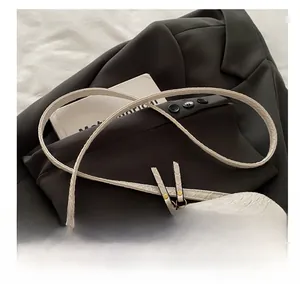 Close-up of white crocodile texture crossbody bag with comfortable strap and metal zipper