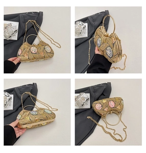 Detailed close-up of sequin floral embroidery and golden circular handle on evening bag