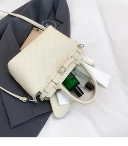 Interior storage space of a cream checkered tote bag with skincare items inside