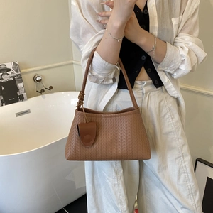 Classic caramel brown woven shoulder bag with small coin purse in a chic minimalist style
