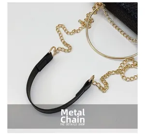 Macro shot of the black woven texture leather and premium gold metal chain strap