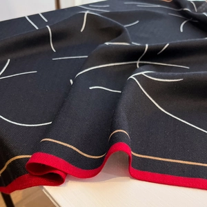 Détail de l'écharpe en chevrons avec lignes blanches et bordure rouge vif