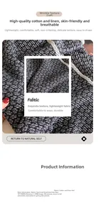 Detail of black and white paisley cotton-linen scarf with pleated texture and dual-use design