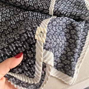 Detail of paisley print linen scarf with pleated texture and decorative white edge