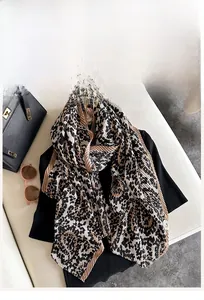 Detail of leopard print pleated scarf with micro-crinkle texture and wavy edges