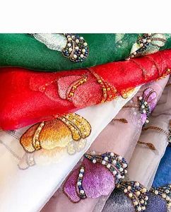 Macro detail of exquisite handmade floral embroidery with shimmering beads and sequins