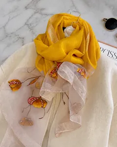 Detail of silk blend scarf featuring floral embroidery and pearls on organza fabric