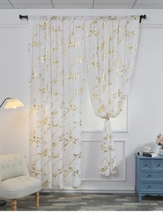 Detail of white velvet curtains with gold marble foil print and metal rod hanging style