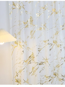 Detail of white Dutch velvet curtain with gold foil marble texture and warm lighting