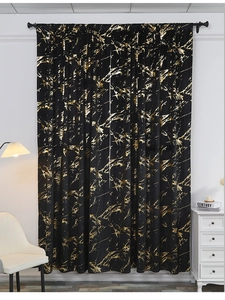 Detail of black blackout curtain with gold marble foil print and luxury velvet texture
