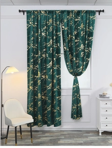 Detail of dark green velvet curtain with gold marble pattern and blackout texture