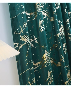 Detail of emerald velvet curtain with luxury gold marble texture and foil print
