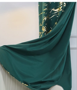 Detail of dark green velvet curtain with gold marble foil print and soft elegant folds