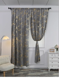 Detail of gray velvet curtains with golden marble patterns and elegant black hanging rings