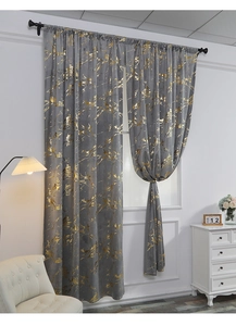 Close-up of grey velvet curtains featuring gold foil marble patterns for a modern living room