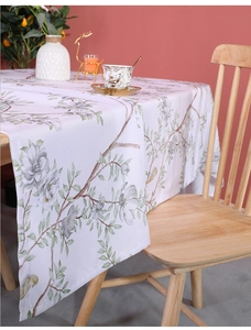 Detailed close-up of floral print tablecloth with lavender flowers and green leaves