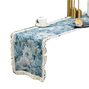 Blue and white floral jacquard table runner with decorative tassels for dining decor