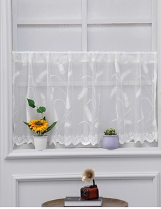 Detailed view of white lace cafe curtain featuring intricate wheat ear embroidery and wavy edge