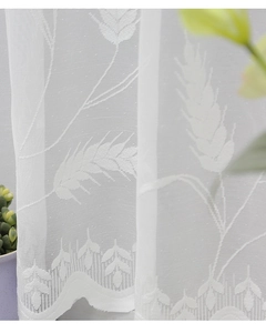 Detailed close-up of white lace curtain featuring delicate wheat ear pattern embroidery
