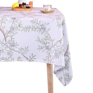 Fresh plant and bird print cotton linen tablecloth on a wooden table for dining room