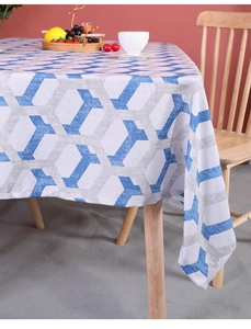 Close-up of geometric pattern on cotton linen tablecloth spread over a wooden dining table
