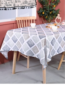 Close-up of geometric diamond pattern on linen tablecloth with elegant draped edges
