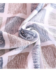 Close-up of linen tablecloth fabric showing geometric pattern and textured weave detail
