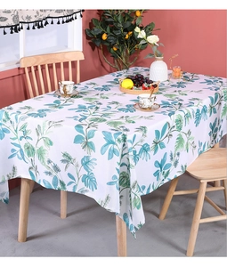 Close-up of tropical green leaves pattern on white cotton linen rectangular tablecloth