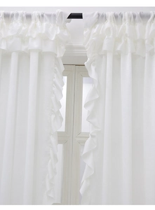 Close-up of white velvet curtain with romantic ruffled edges and layered top design