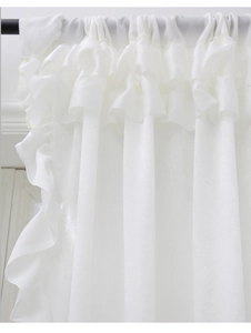 Detail of white ruffled rod pocket curtain with elegant layered fabric texture