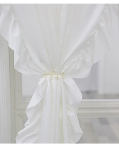 Macro shot of white pearls and golden silk woven headband on elegant ruffled fabric