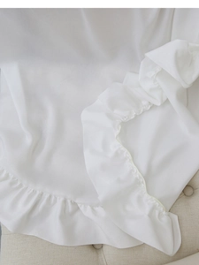 Close-up of elegant white ruffled sheer curtain fabric with delicate velvet texture