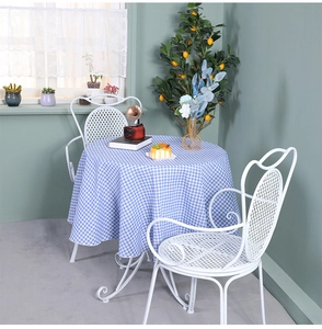 Detail of blue and white gingham cotton linen tablecloth with natural soft draping