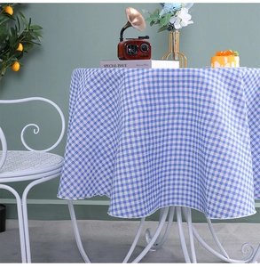 Detailed view of blue and white checkered round tablecloth with cotton linen texture