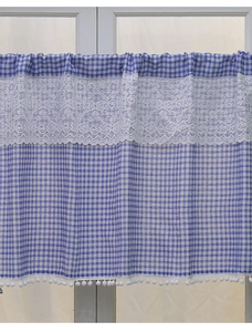 Detail of blue and white plaid cafe curtain with floral lace and white pom-pom trim