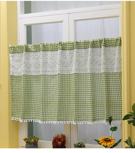 Detail of green plaid cafe curtain with white lace splice and pompom trim on window