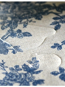 Gros plan du tissu imperméable avec motif floral et gouttes d'eau sur la surface