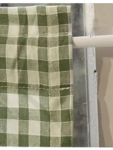 Close-up of green and white checkered cafe curtain with durable rod pocket stitching