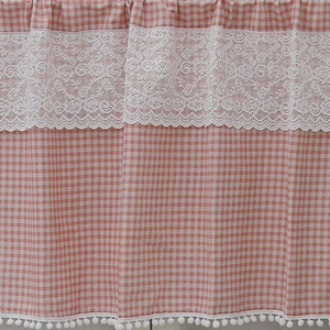 Pink checkered cafe curtain with white floral lace trim and decorative pom-pom fringe