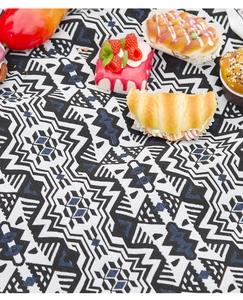 Detailed weave of Bohemian picnic mat with geometric patterns and outdoor snacks