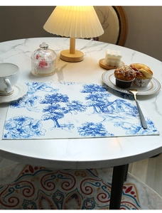 Detailed blue French Toile de Jouy pattern on a premium linen tablecloth for home dining