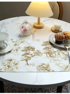 Toile de Jouy style linen placemat with vintage scenery on a marble table