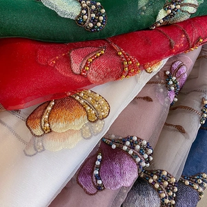 Close-up of luxury silk blend scarf with heavy embroidery and beadwork details