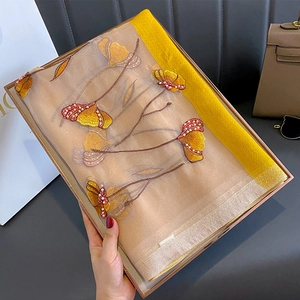Elegant silk blend scarf featuring intricate floral embroidery and delicate pearl accents