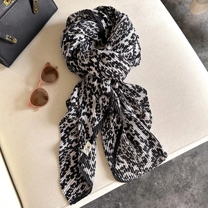 Stylish black and white leopard print pleated scarf with elegant accordion fold texture