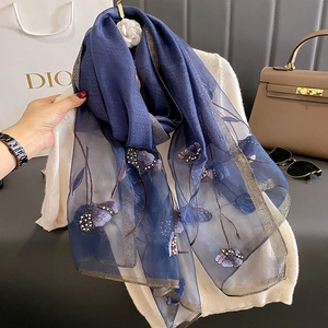 Detailed embroidery and beads on dark blue silk blend scarf with golden edges