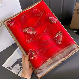 Detailed embroidery and handcrafted beads on a red silk blend luxury scarf for women