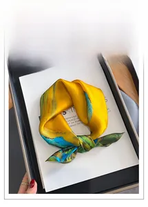 Detail of artistic silk square scarf featuring abstract green and blue landscape prints